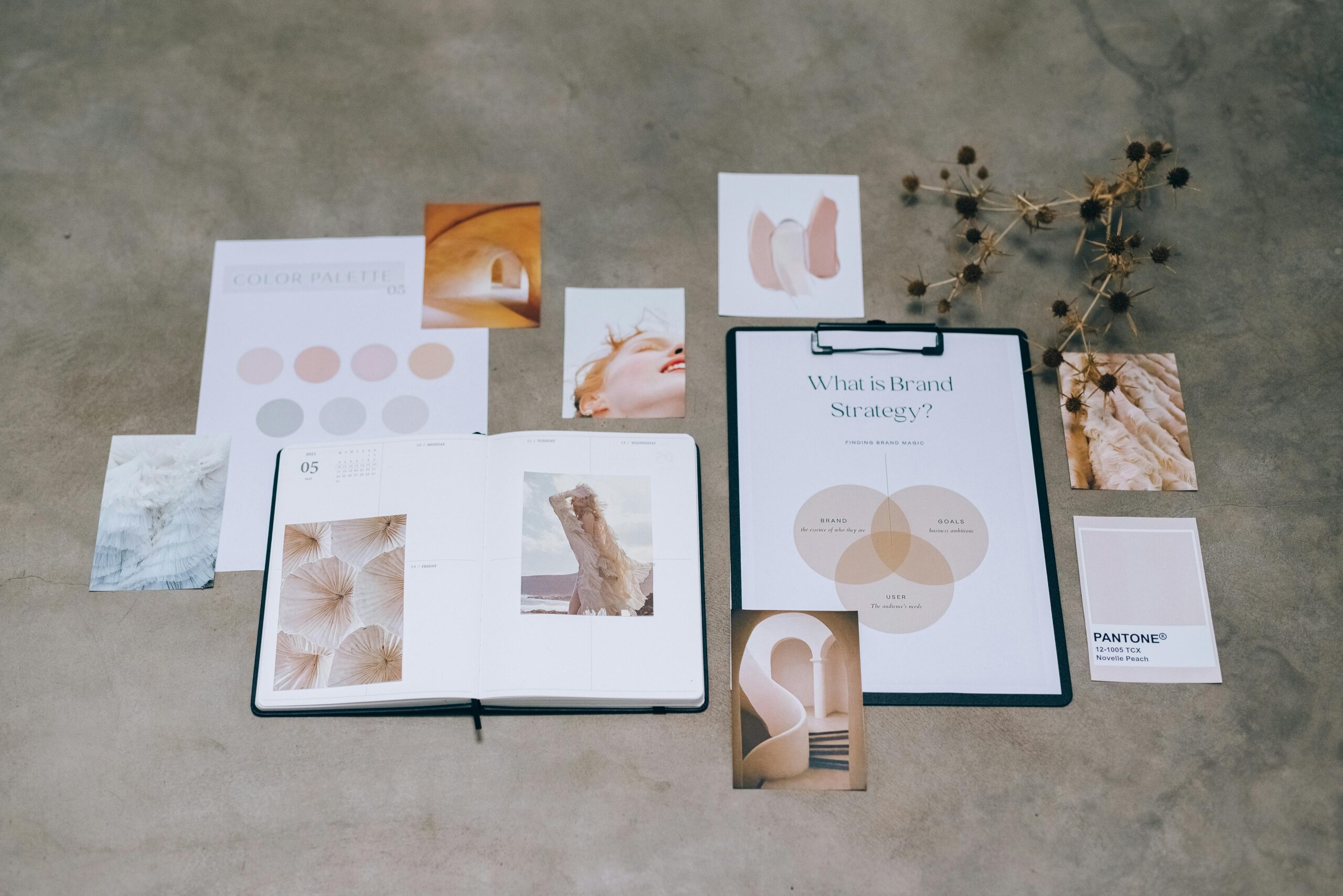 Home A flat lay of branding elements with color palettes and strategic planning documents on a concrete surface.